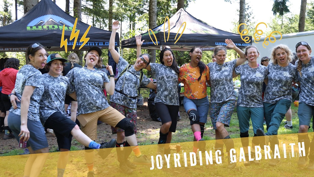 JoyRiders celebrating at a Galbraith event in matching tie-dye jerseys